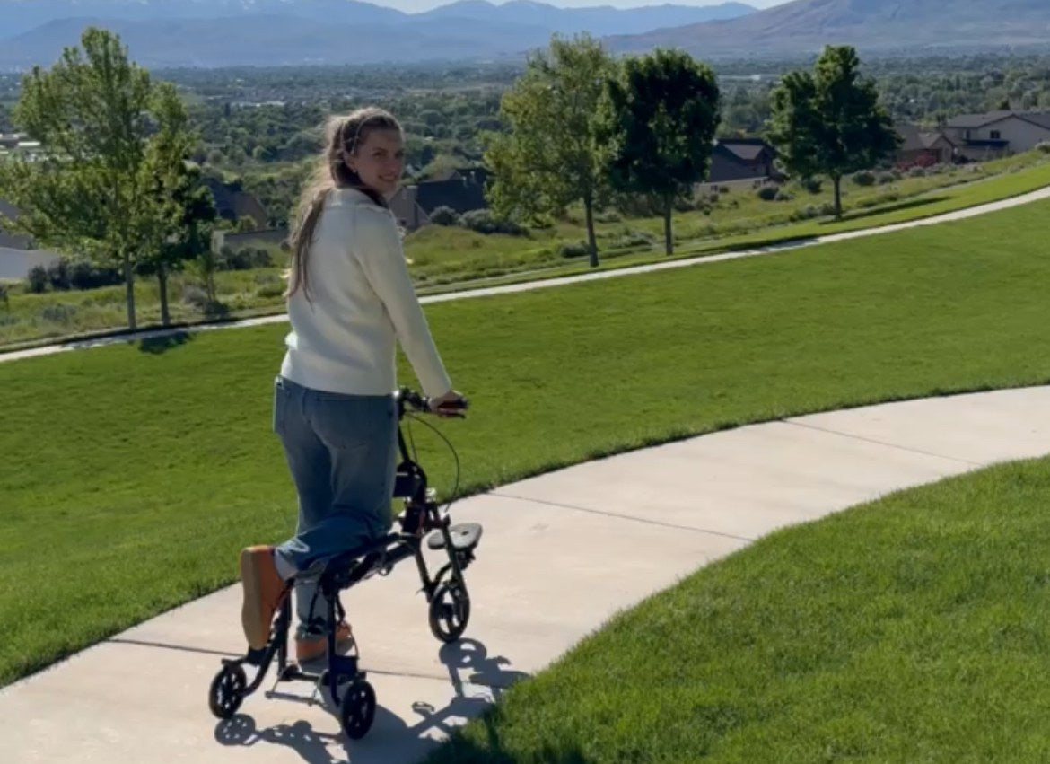 EaziStep scooter-crutch moving on a paved path near grass